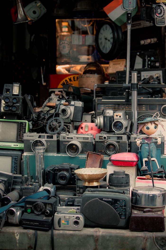 Mastering the First Impression: Your intriguing post title goes here Collection of vintage cameras, radios, and electronics on display in an antique shop.